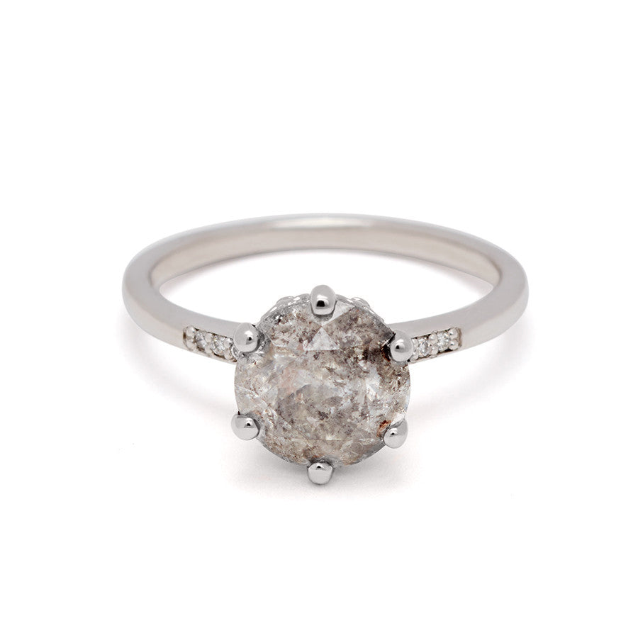 A solitaire ring with a 2.00ct round galaxy grey diamond with white diamond pave on either side set in white gold., White Gold