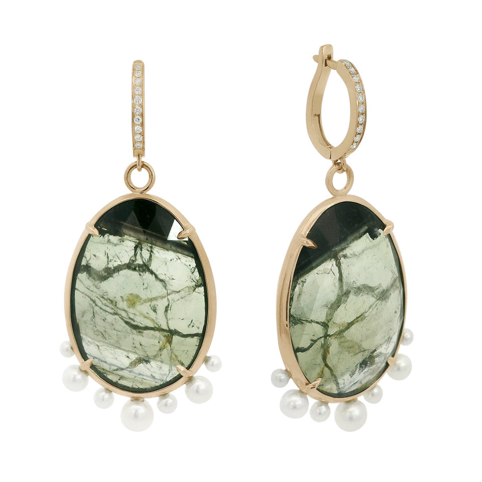 Pair of earrings with green stone and pearl accents on a white background
