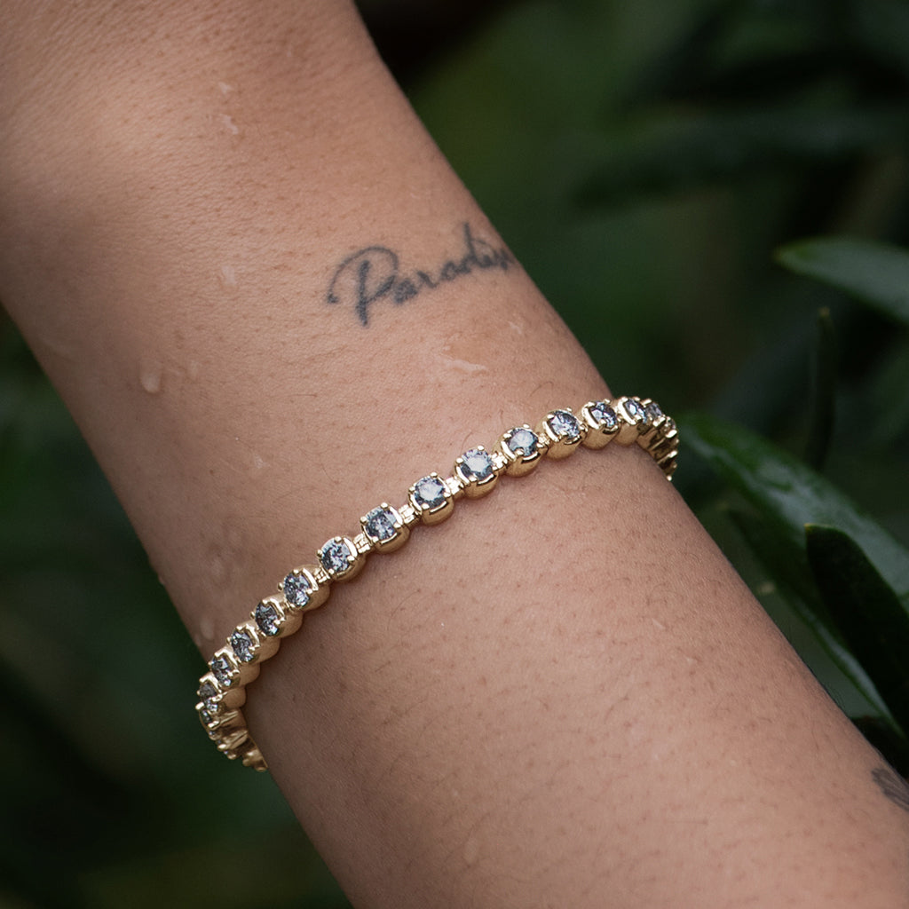 Female wrist wearing Ingot Eternity Bracelet - Yellow Gold & Grey Diamonds