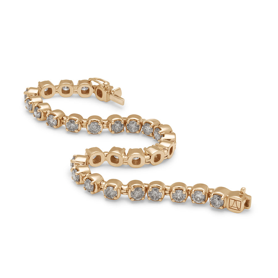 Zig zag view of a line bracelet with grey diamonds set in eternity in yellow gold.