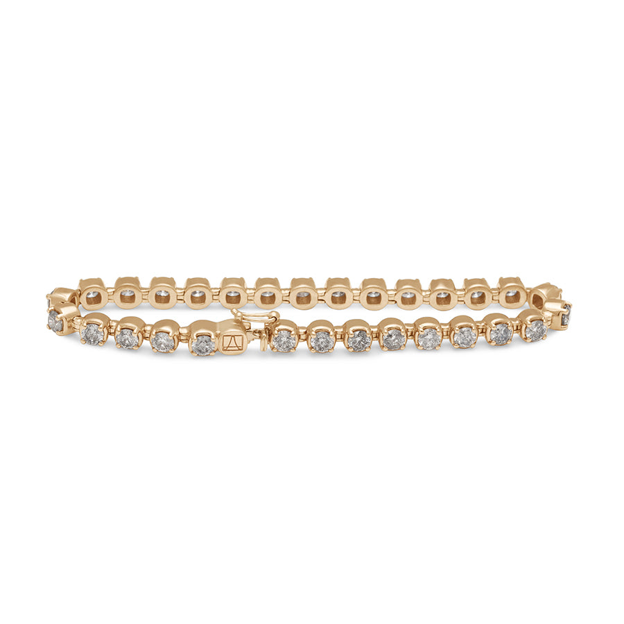 A straight view of a line bracelet with grey diamonds set in eternity in yellow gold.