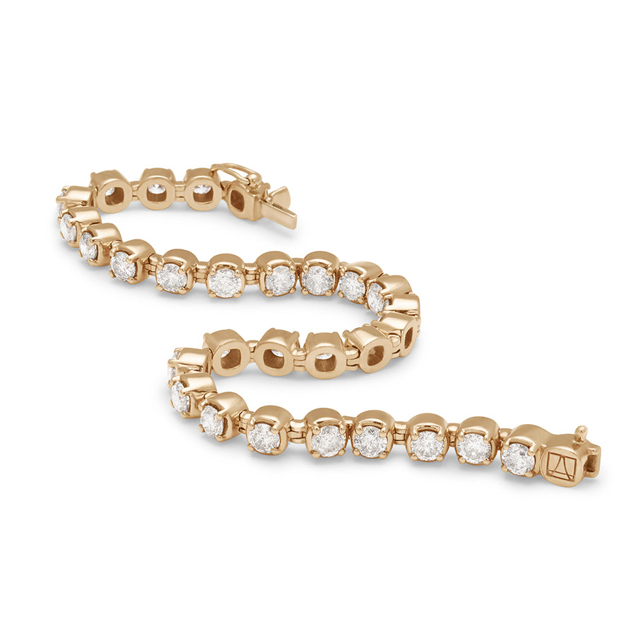 A swirled view of a line bracelet with lab white diamonds set in eternity in yellow gold.