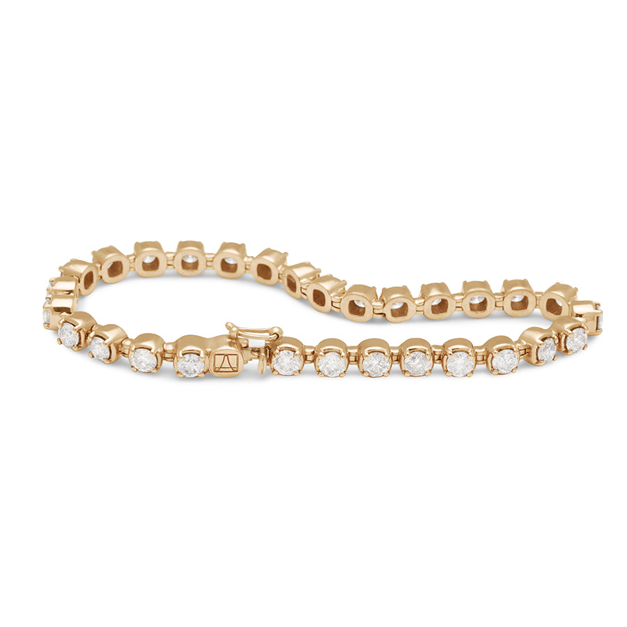 A swirled view of a line bracelet with lab white diamonds set in eternity in yellow gold.