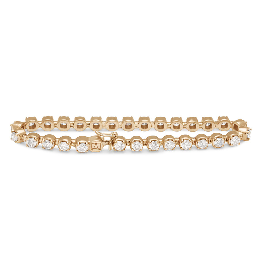 A straighten view of a  line bracelet with lab white diamonds set in eternity in yellow gold.