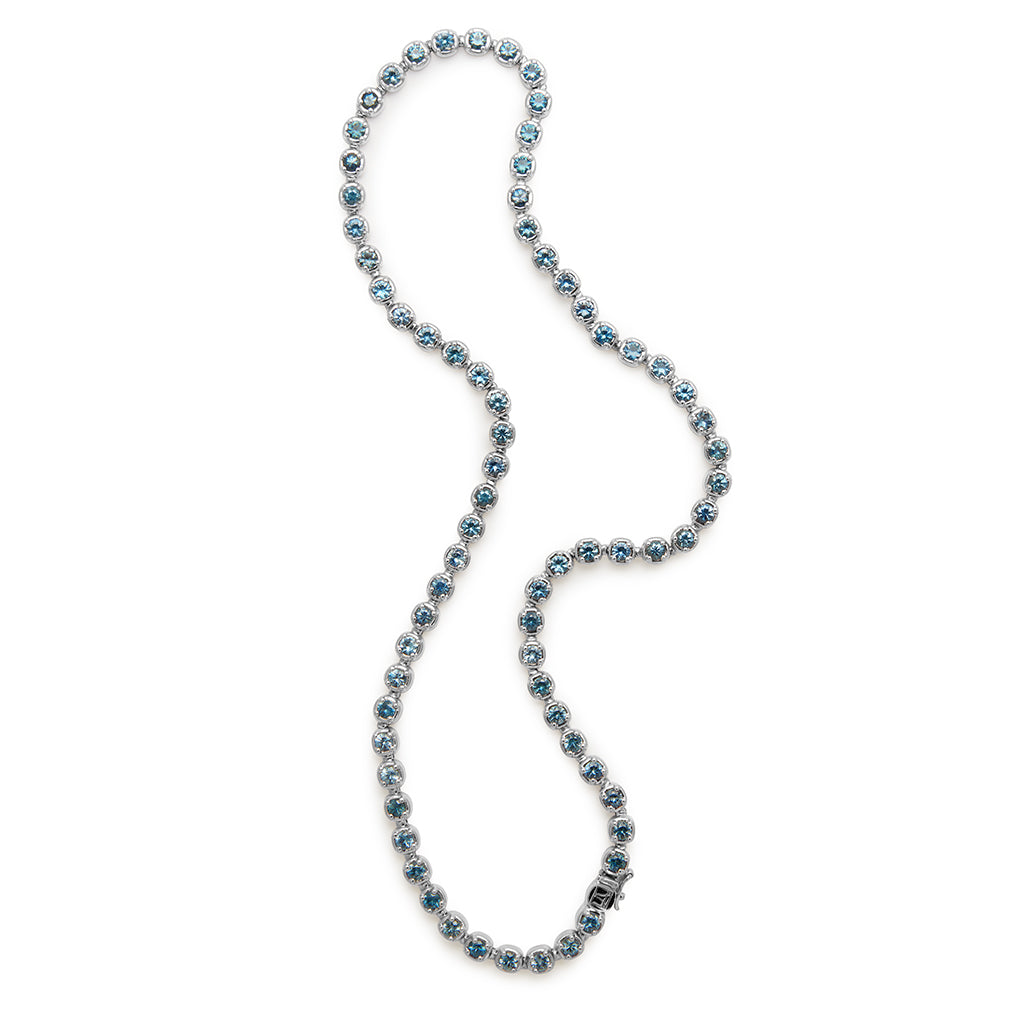 A swirled line necklace with Montana sapphires set in eternity in white gold.