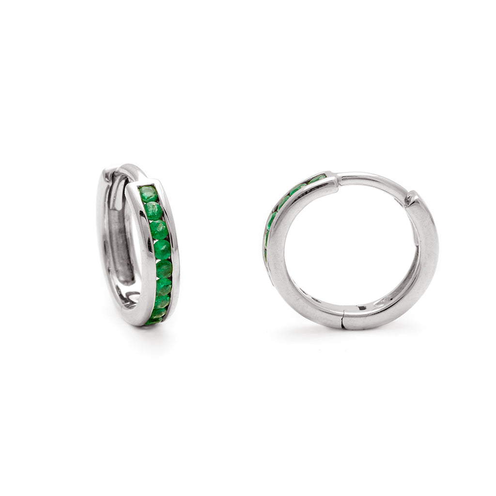 A pair of hoops with a line of green emeralds set in sterling silver one angled to the side.