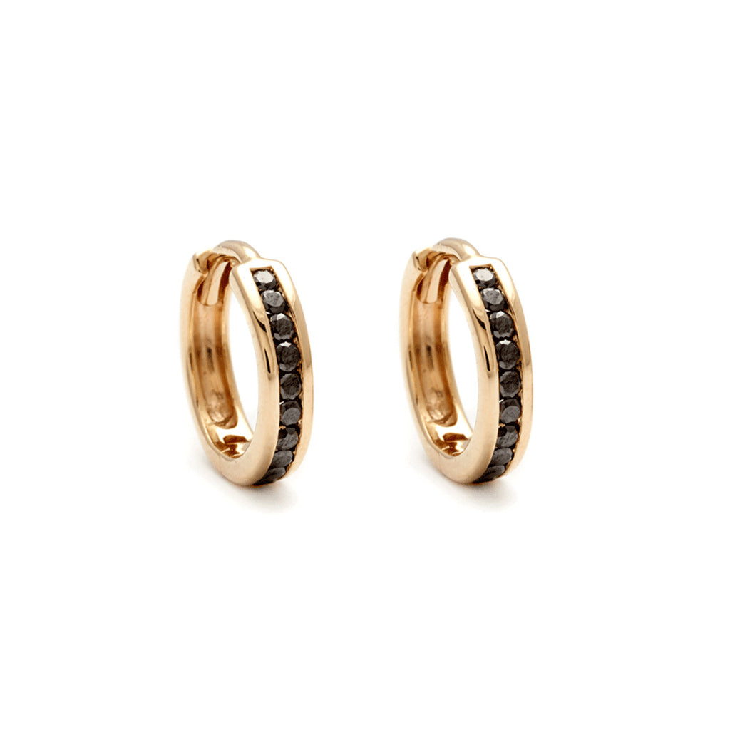 A pair of hoops with a line of black diamonds set in yellow gold.