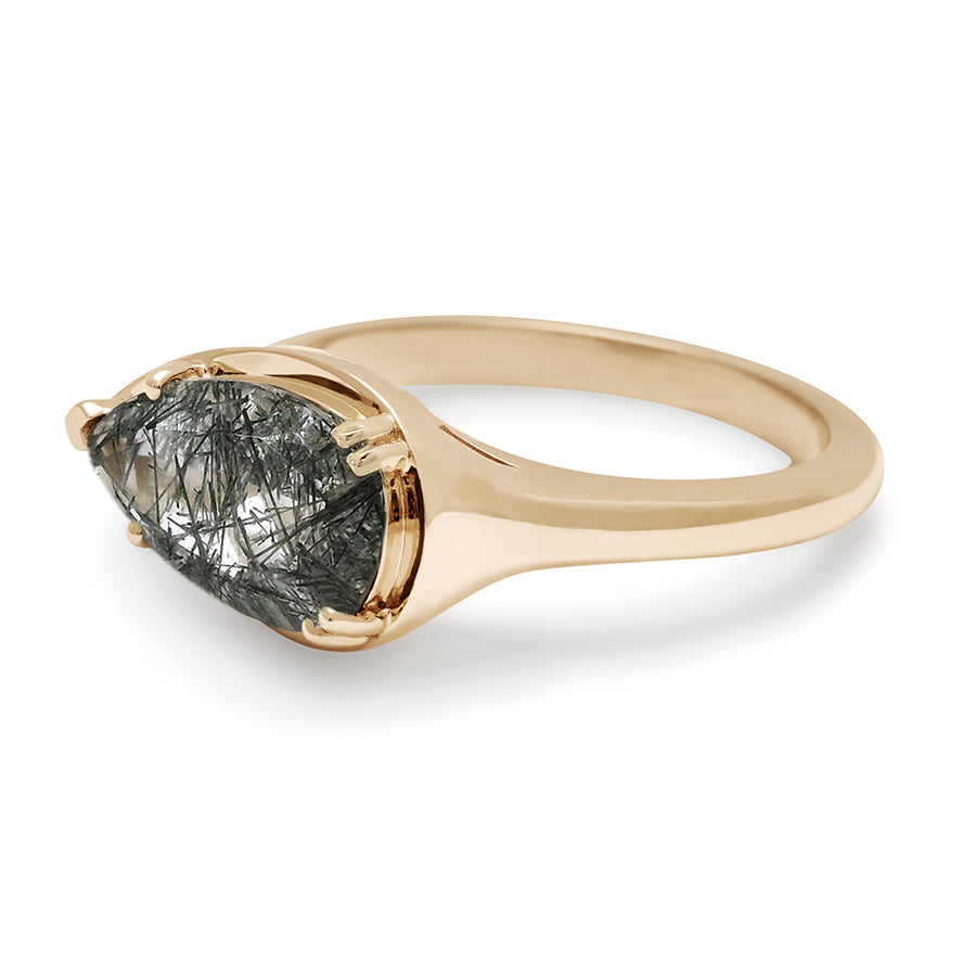 Angled view of a solitaire ring pear shaped black rutilated quartz set in yellow gold.