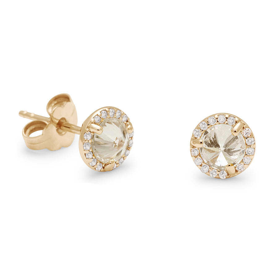 One front angle and one 3/4 angle of two champagne diamond studs featuring a white diamond halo set in yellow gold against a white background. 