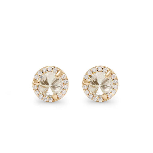 Front angle of two champagne diamond studs featuring a white diamond halo set in yellow gold against a white background. 