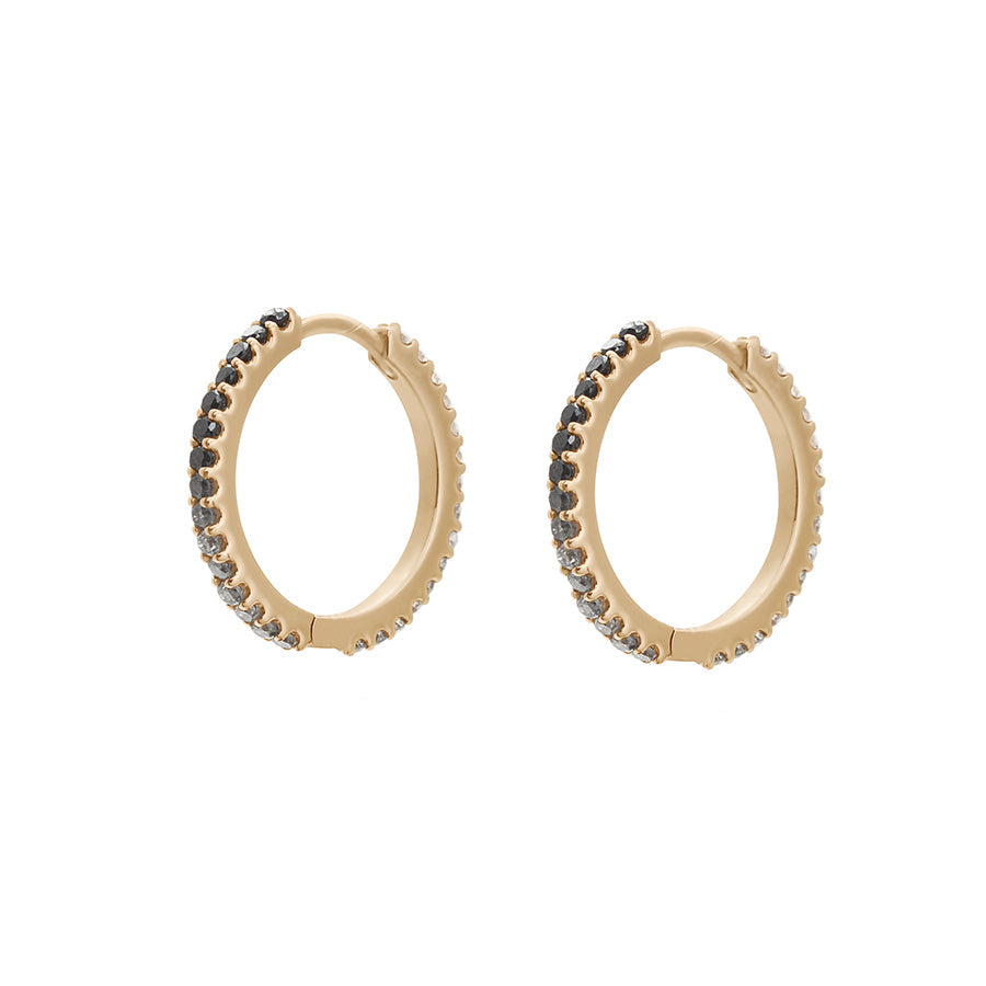 A pair of eternity hoops with ombre of black to grey to white diamonds set in yellow gold both earrings angled with no droplet.
