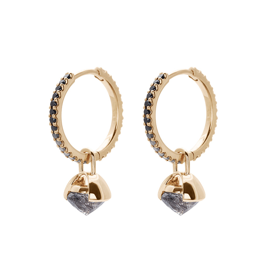 A pair of eternity hoops with ombre of black to grey to white diamonds with a black rutilated quartz droplet set in yellow gold both earrings angled.