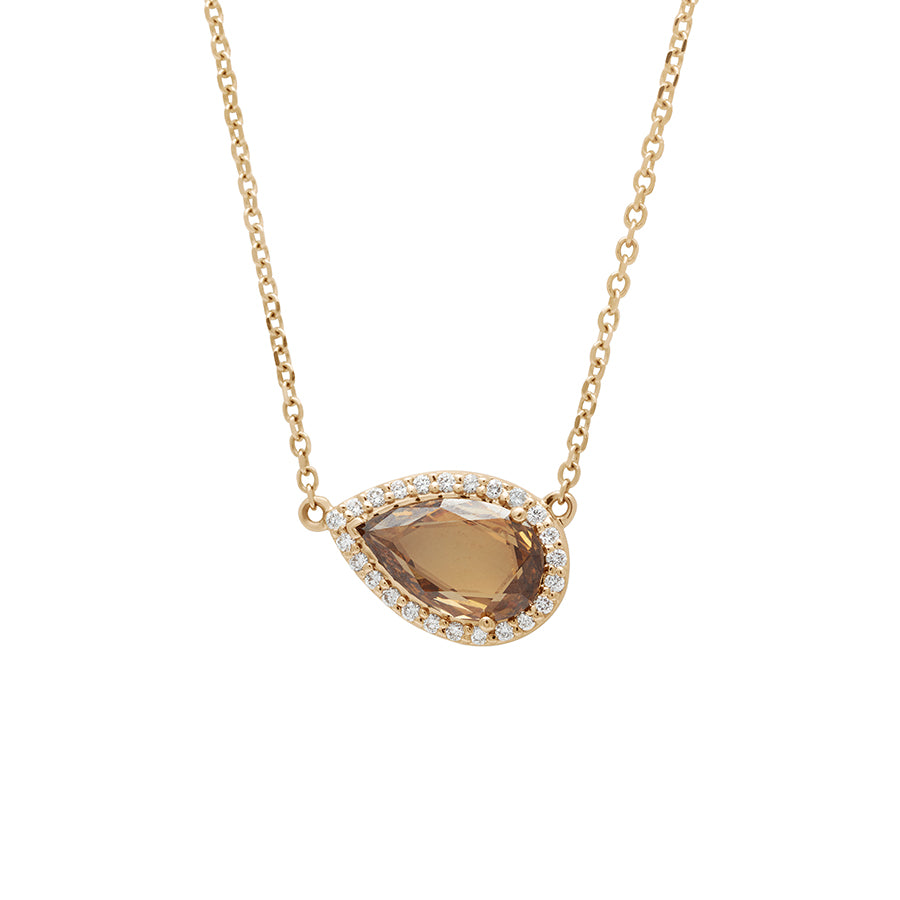 Zoomed in view of a pear necklace with a champagne diamond with white diamond halo in yellow gold with a yellow gold chain.