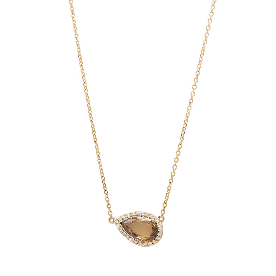 Zoomed out view of a pear necklace with a champagne diamond with white diamond halo in yellow gold with a yellow gold chain.
