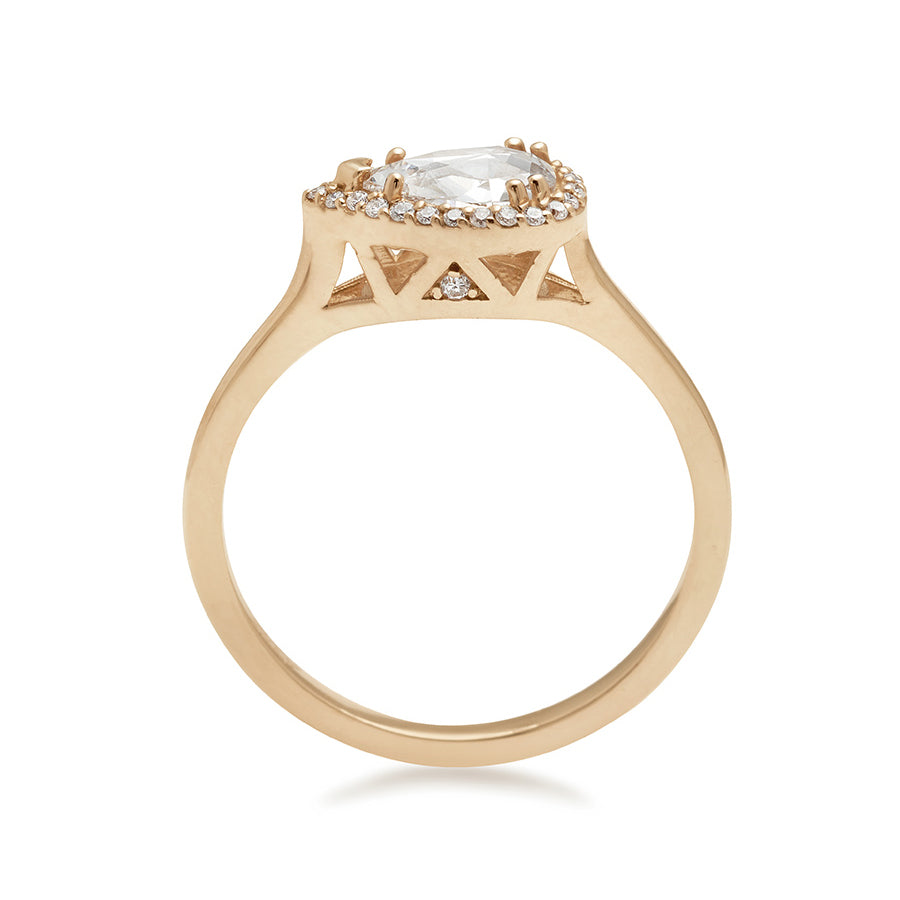 Side view of a pear shaped ring with a white diamond and white diamond halo set in yellow gold.