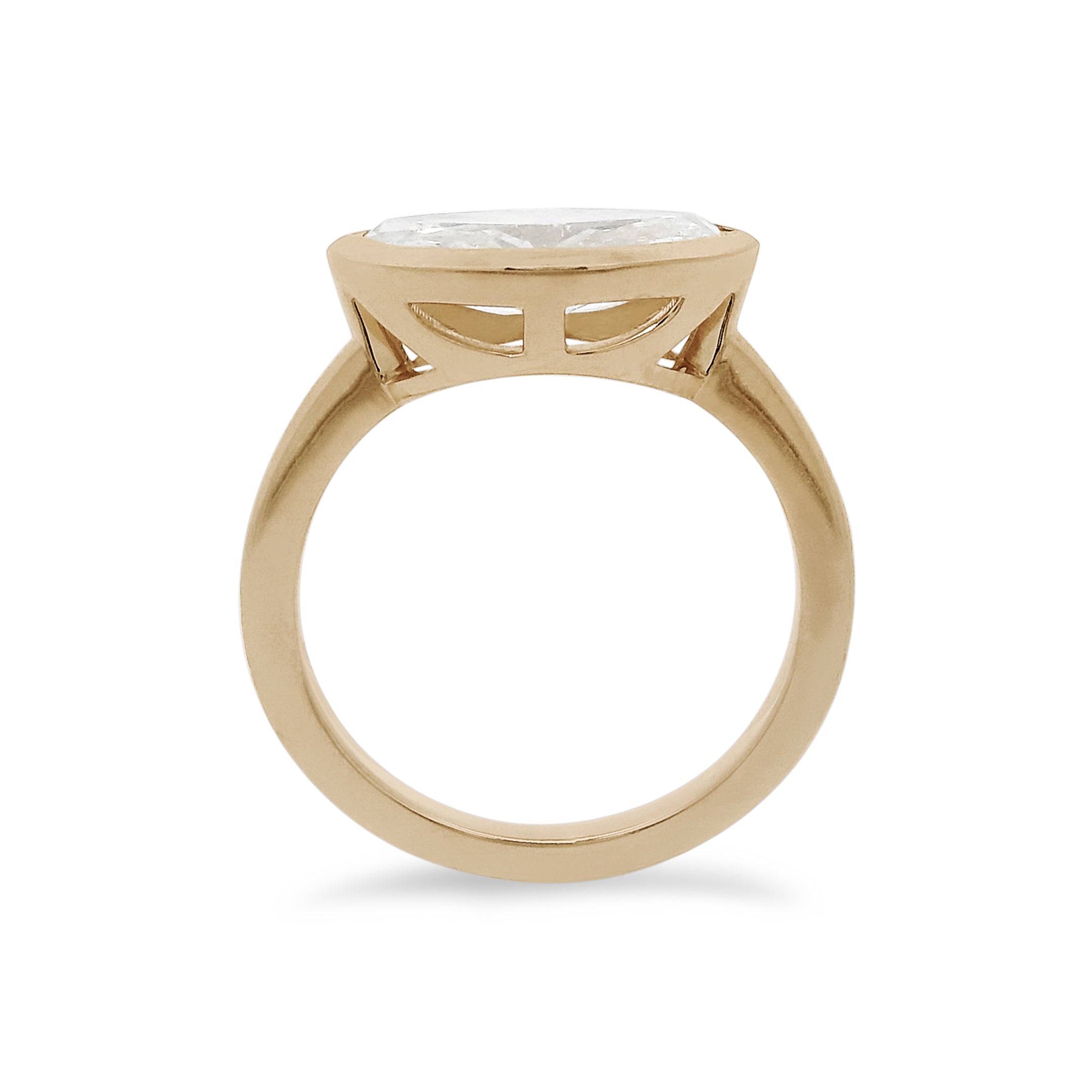 A white moval cut diamond set east west in a yellow gold bezel setting. 