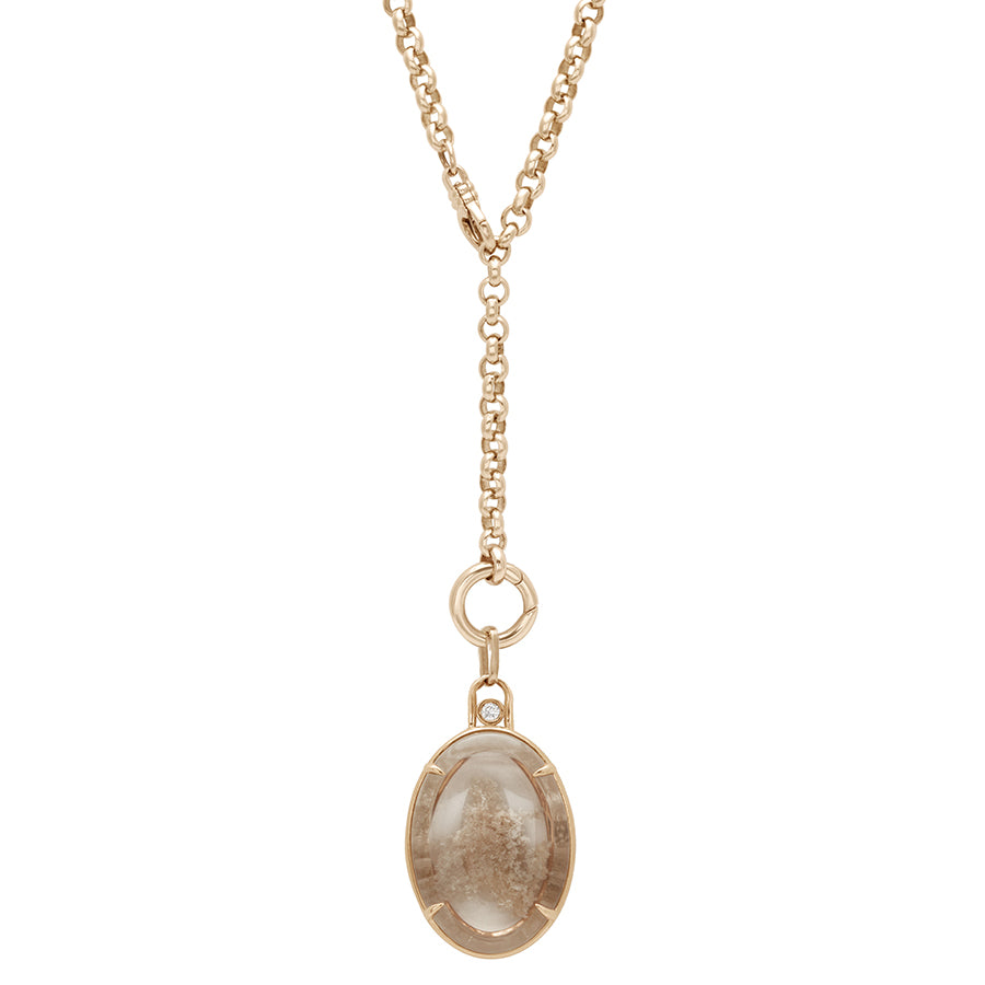 A rolo yellow gold chain styled in a "Y" design with an oval terra firma charm at the bottom.