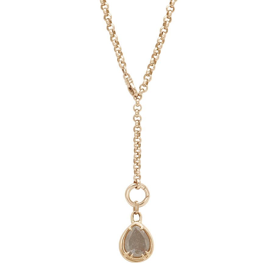 A rolo yellow gold chain styled in a "Y" design with a pear grey diamond charm at the bottom.