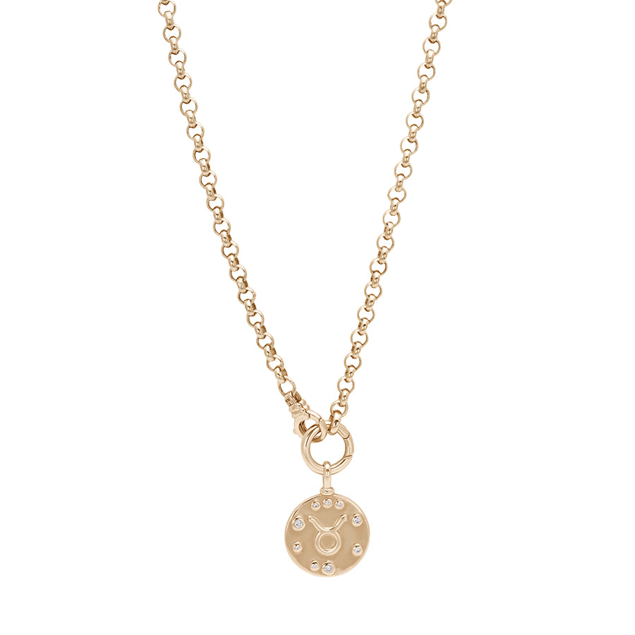 A rolo yellow gold chain with a constellation zodiac charm at the bottom.