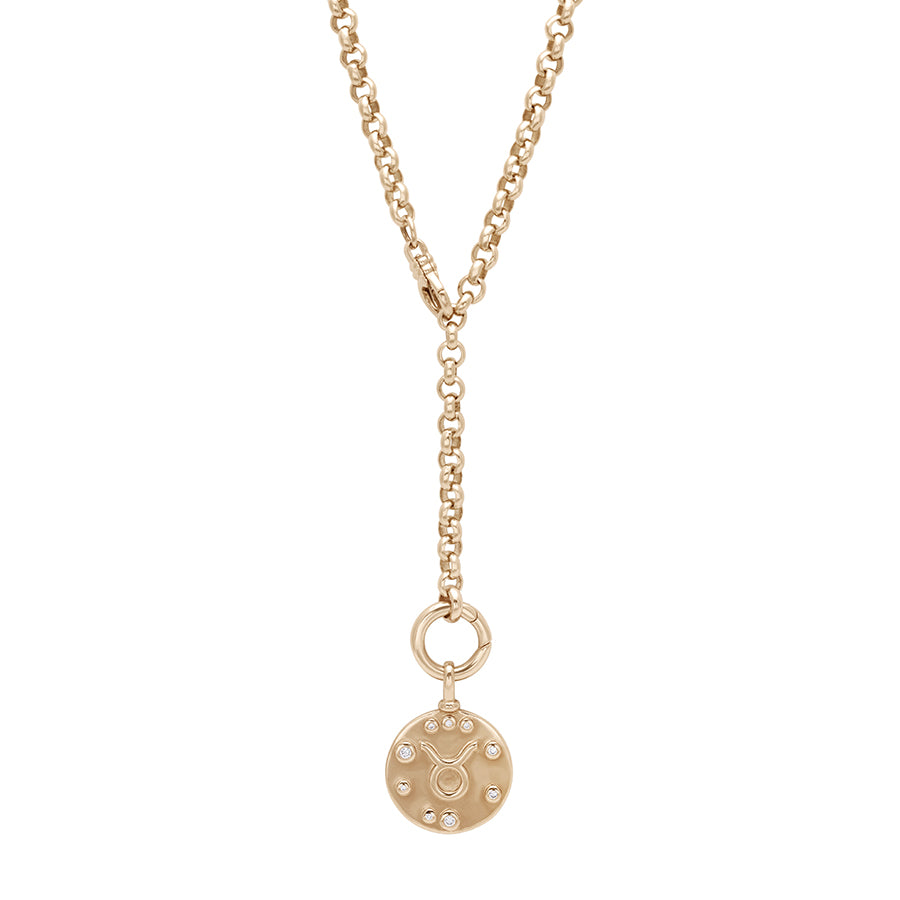 A rolo yellow gold chain styled in a "Y" design with a constellation zodiac charm at the bottom.