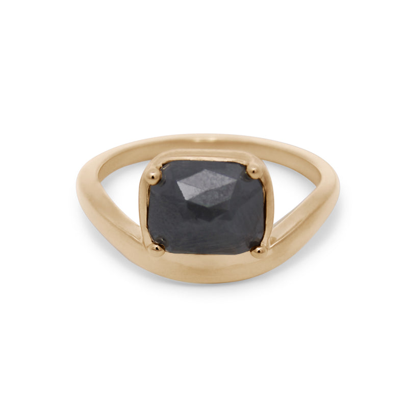 Gold ring with a black gemstone on a white background