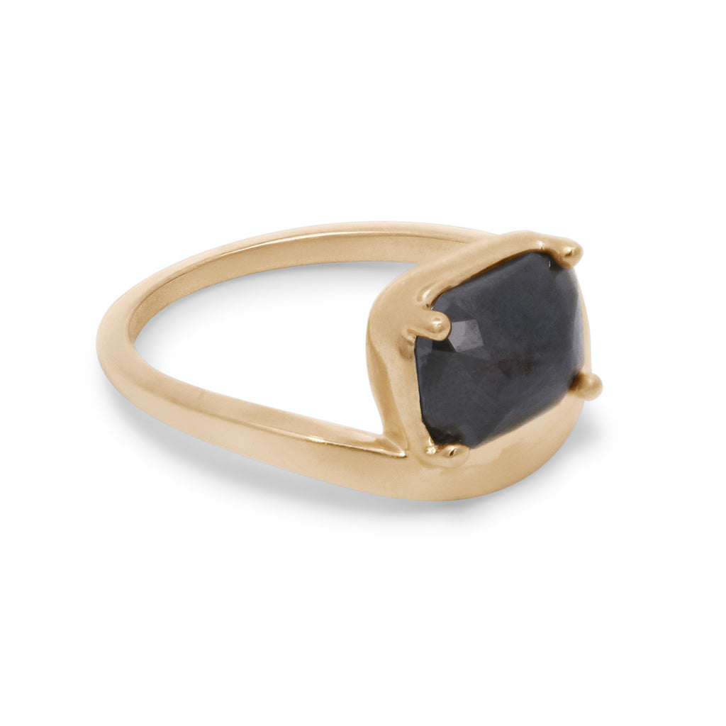 Gold ring with a black gemstone on a white background