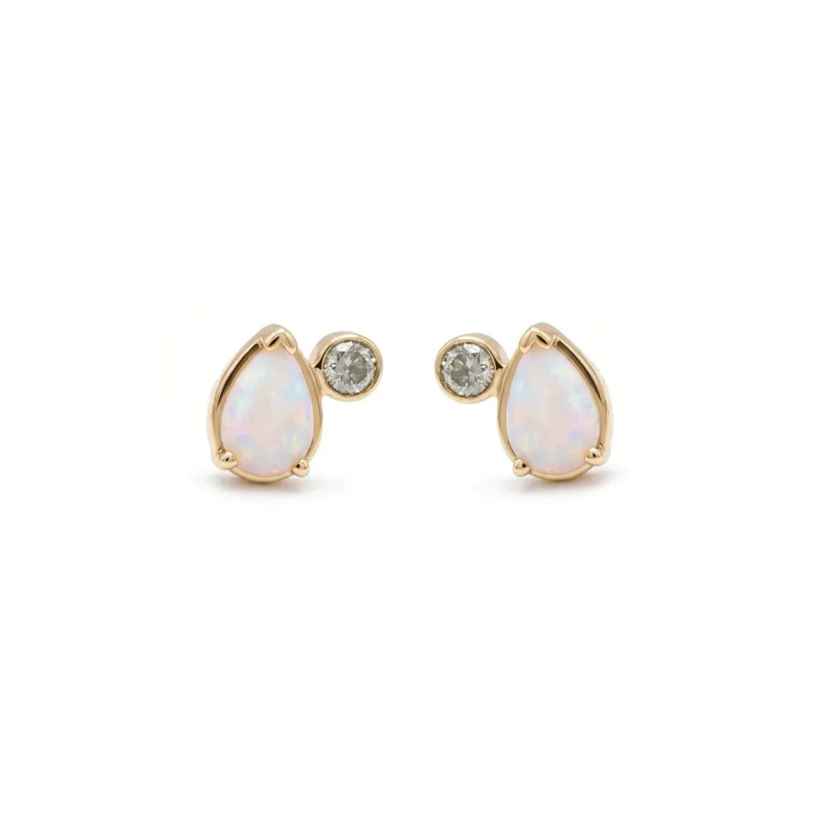 A pair of stud earrings featuring pear cut opals and round grey diamonds set in yellow gold against a white background