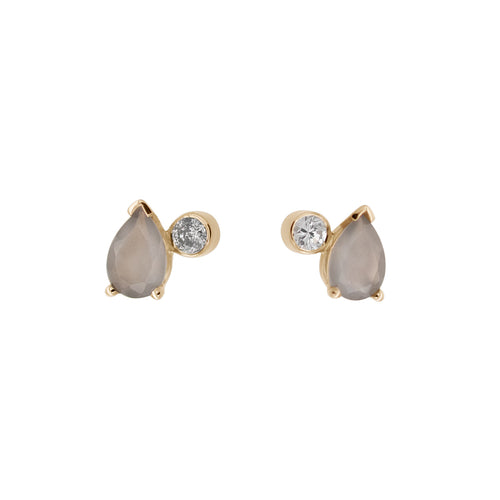 A pair of stud earrings featuring pear shaped grey moonstones and round grey diamonds set in yellow gold on a white background.