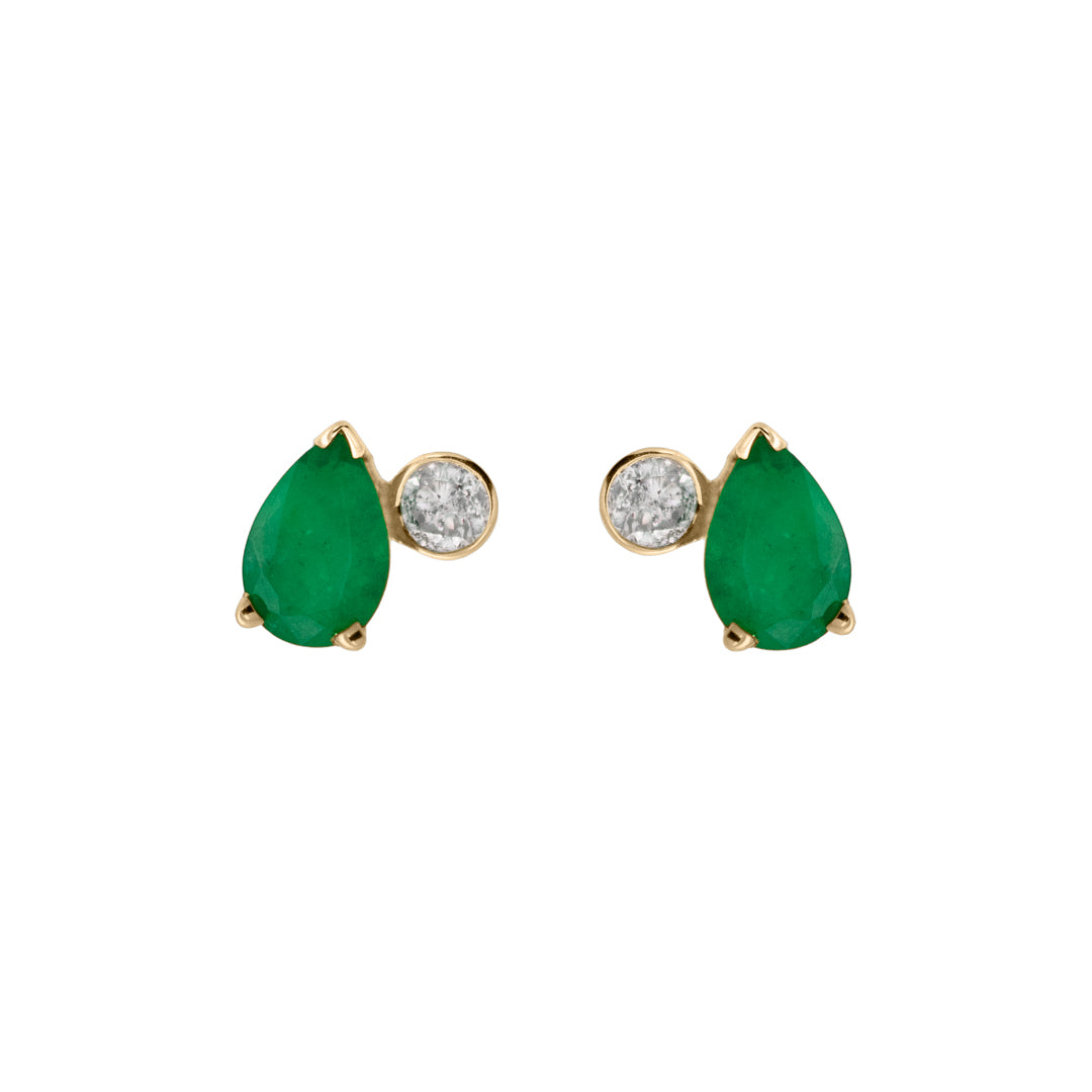A pair of stud earrings featuring white round diamonds and pear shaped green emeralds set in yellow gold on a white background