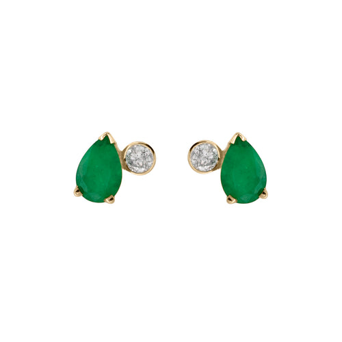 A pair of stud earrings featuring white round diamonds and pear shaped green emeralds set in yellow gold on a white background