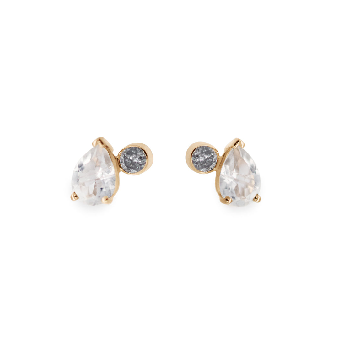 A pair of stud earrings featuring pear shaped rainbow moonstones and round grey diamonds set in yellow gold on a white background.
