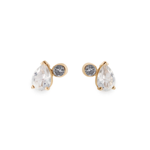 A pair of stud earrings featuring pear shaped rainbow moonstones and round grey diamonds set in yellow gold on a white background.