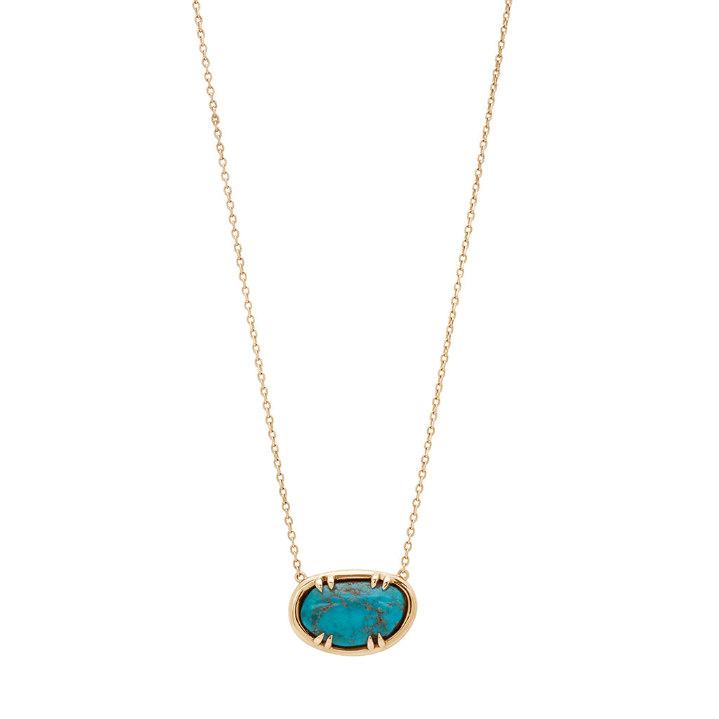 Zoomed out view of an oval necklace with a turquoise stone set in bezel with claw prongs in yellow gold with a yellow gold chain.