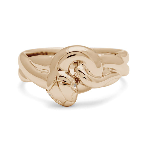 Yellow gold serpent ring with white diamond eyes on white background