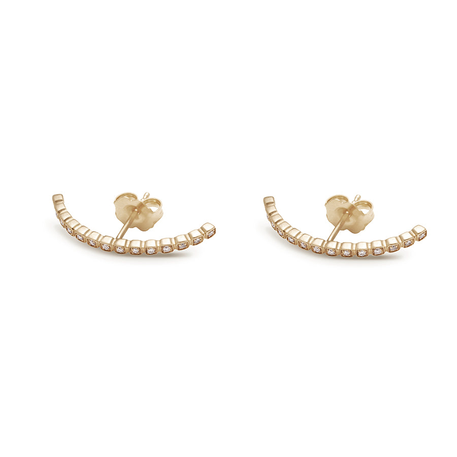 A pair of white diamond dusted curve earrings set in yellow gold both earrings on their side., Yellow Gold