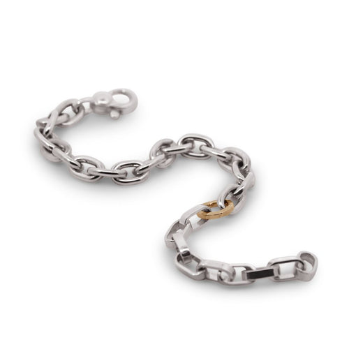 Silver chain bracelet with a gold clasp on a white background