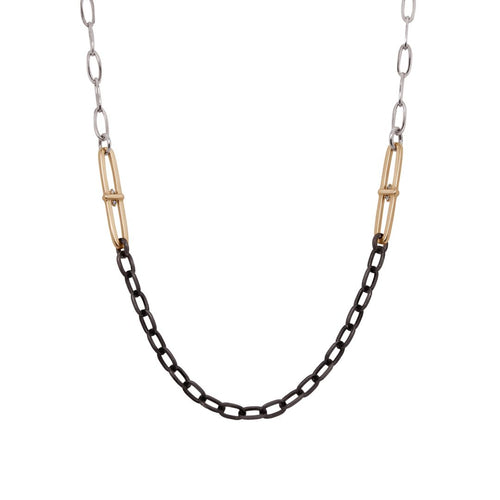 Necklace with black and gold paperclips mottifs with white diamonds on a silver chain on a white background