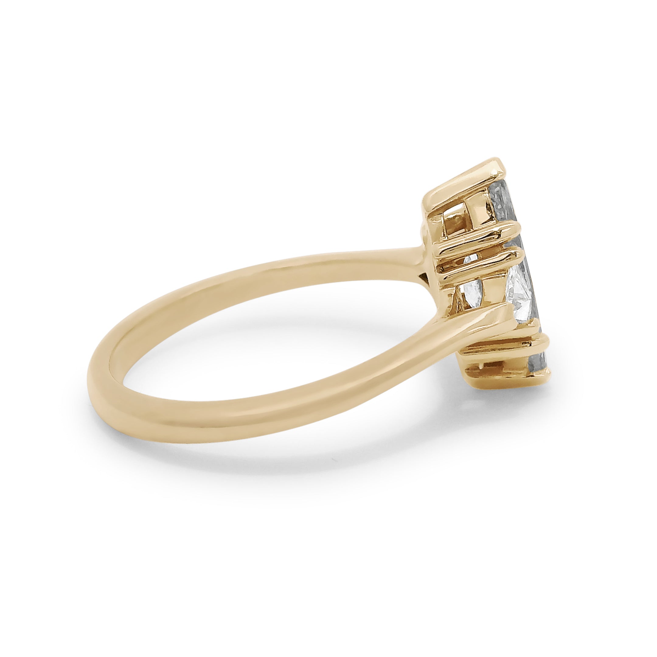 Three stone ring featuring a marquise cut grey diamond with white trillion diamond side stones set in yellow gold. 