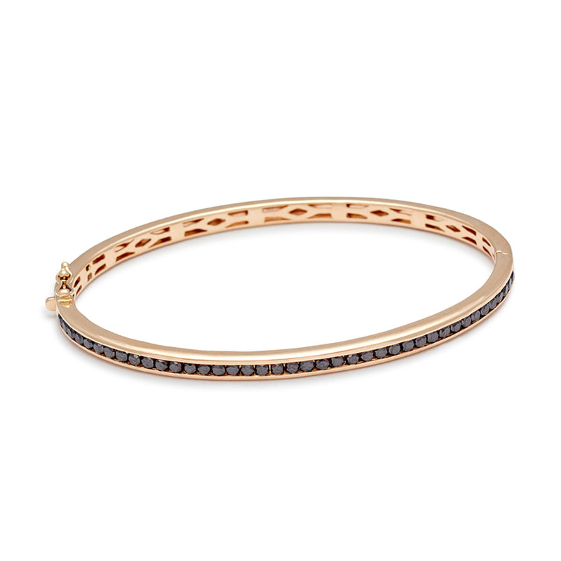 A bracelet with a line of black diamonds set around the band set in yellow gold.