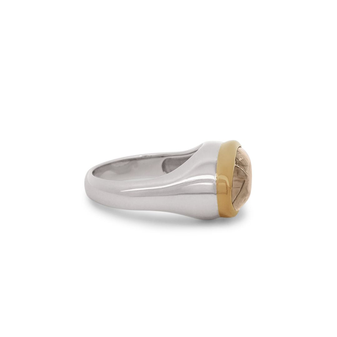 Side profile of a terra firma cabochon quartz signet ring bezel set in a 14k yellow gold bezel and sterling silver shank. 