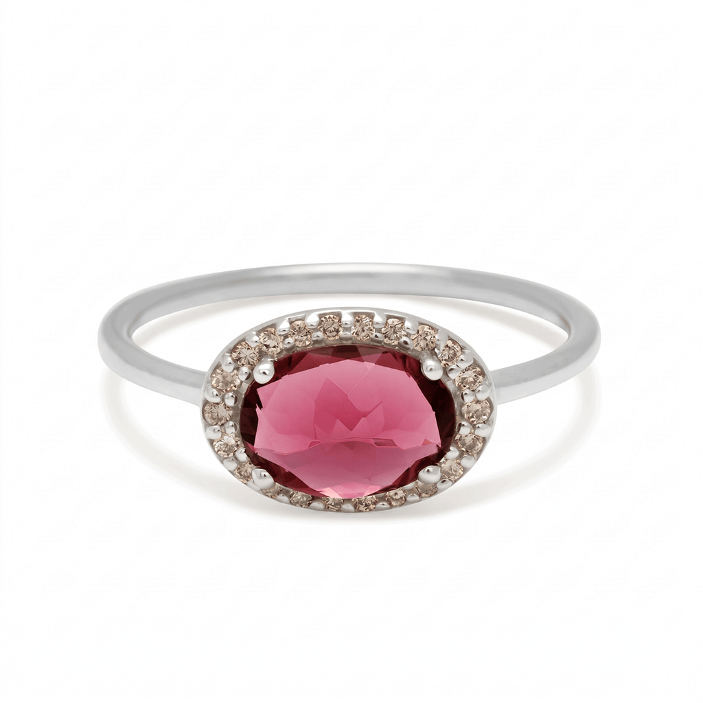 Silver ring with a pink gemstone on a white background