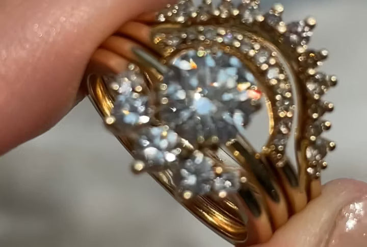 A video of a stack of rings being held by two fingers rotating back and forth.