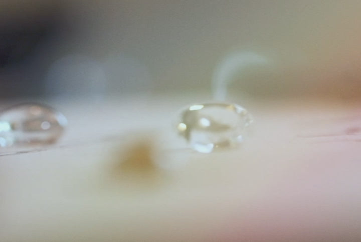 Diamonds on a table and between tweezers during the custom process