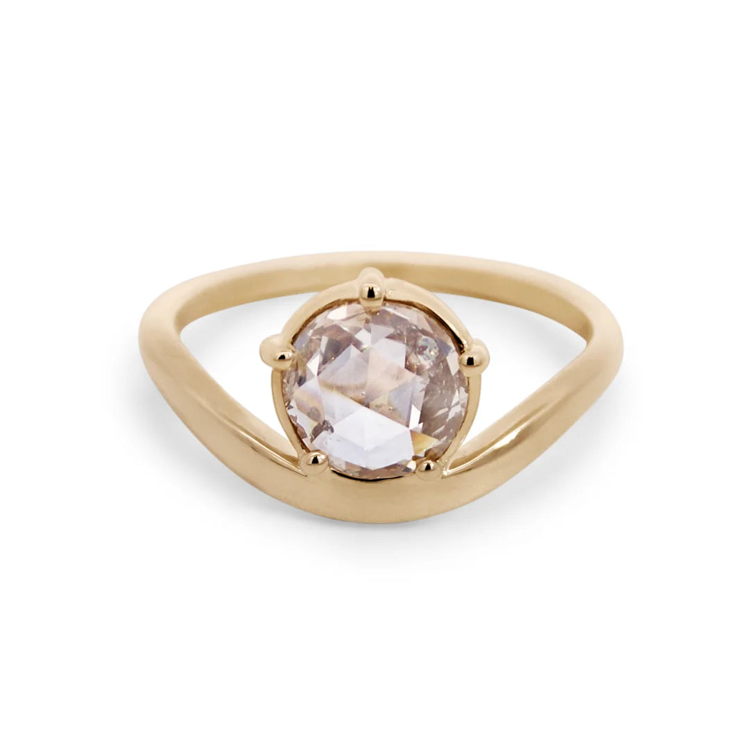 Gold ring with a round rose cut champagne diamond on a white background