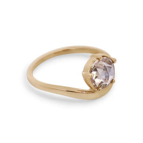 Gold ring with a round rose cut champagne diamond on a white background