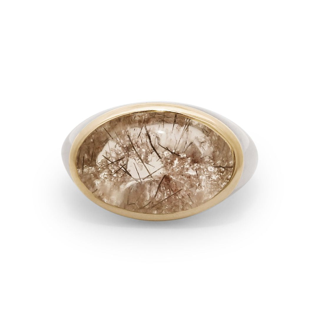 A terra firma cabochon quartz signet ring bezel set in a 14k yellow gold bezel and sterling silver shank. 