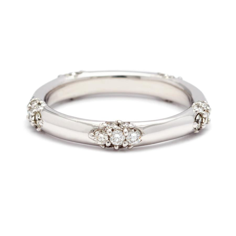 A five cluster white diamond band in white gold.