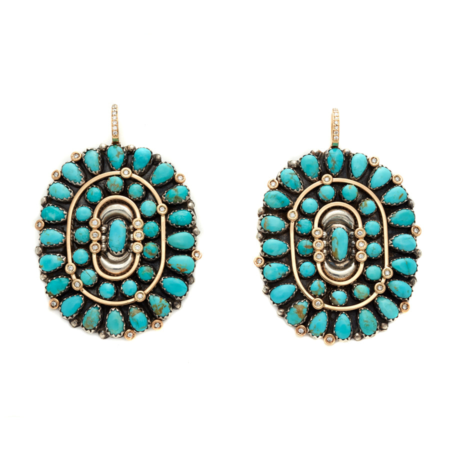 A pair of oval cabochon hoops with turquoise stones and a white diamond pave on the hook of the earring.