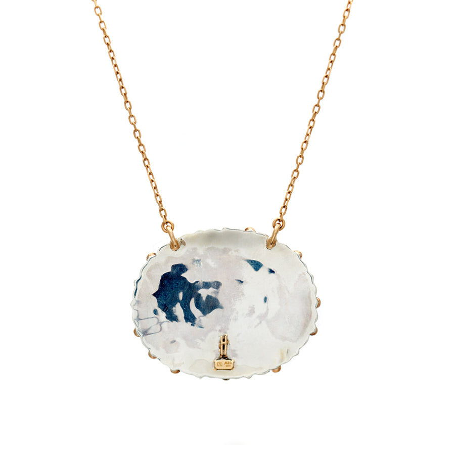 Back side view of an oval cabochon charm with turquoise stones on a 16" chain in yellow gold.