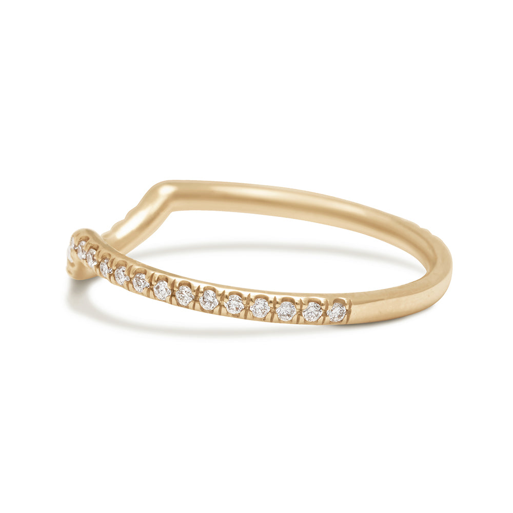 Angled view of a white diamond scalloped band with dusted white diamond around the band set in yellow gold.